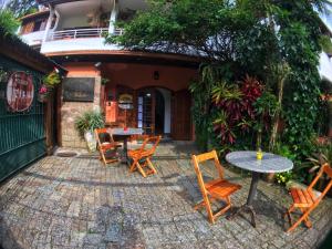 a patio with tables and chairs in front of a building at Pousada Bizkaia in Florianópolis