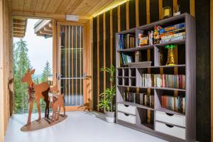 a room with a book shelf with books at La Locanda del Cantoniere - Ciasa Vervei in Cortina dʼAmpezzo