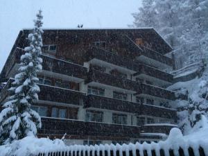 a building covered in snow in front at Bolero Appartements in Zermatt