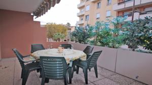a table and chairs sitting on a balcony at Regina - Victoria in Sainte-Maxime +35 photos