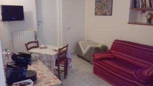 a living room with a table and a couch at Casa Galli in Castel Giorgio