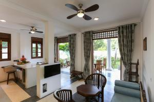 a living room with a ceiling fan and a tv at Annavilla in Tangalle