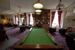 a living room with a green pool table at The White Hart Hotel in Hayle