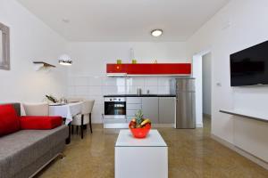 a living room with a couch and a kitchen at Ark Beach Apartments in Split