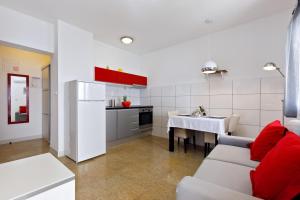a living room with a couch and a kitchen at Ark Beach Apartments in Split