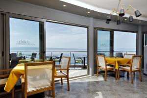 a dining room with a view of the ocean at Ark Beach Apartments in Split