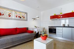a kitchen and living room with a couch and a table at Ark Beach Apartments in Split
