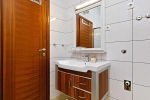 a bathroom with a sink and a mirror at Ark Beach Apartments in Split +37 photos