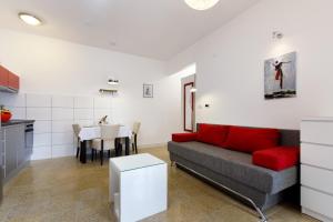 a living room with a couch and a table at Ark Beach Apartments in Split