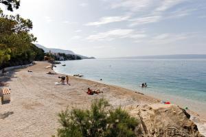 a group of people on a beach near the water at Ark Beach Apartments in Split