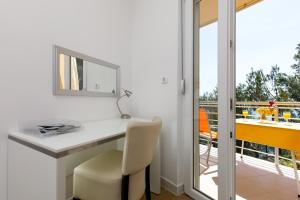 a white desk with a chair and a mirror at Ark Beach Apartments in Split