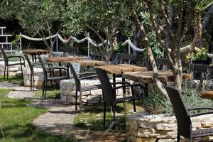 a group of tables and chairs in a park at Ark Beach Apartments in Split