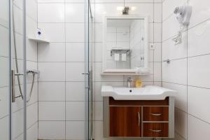 a bathroom with a sink and a shower at Ark Beach Apartments in Split