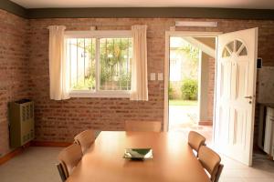a dining room with a table and a window at Complejo Sierras Blancas in Las Grutas