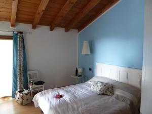 Postel nebo postele na pokoji v ubytování B&B Il Melograno