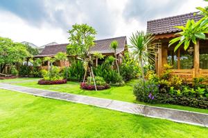a house with a garden in front of it at Bali Natha Beach Front in Canggu