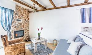 a living room with a couch and a fireplace at Limeri Traditional Guest House in Monólithos