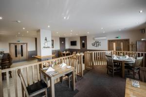 a restaurant with wooden tables and chairs in a room at Seaview Hotel in Peterhead