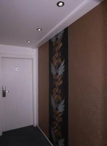 a hallway with a wall with a curtain with birds on it at Hotel Savoy Bonn in Bonn