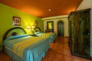 Кровать или кровати в номере Hotel Chichen Itza