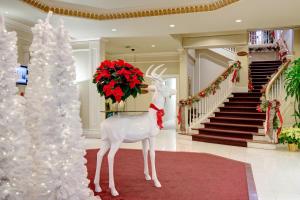 a christmas tree and a statue of a reindeer in a lobby at Queens Landing in Niagara-on-the-Lake