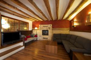 a living room with a couch and a tv at Posada Guadalupe in Monroyo