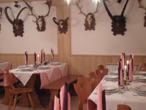 a dining room with a table and chairs with candles at Hotel La Molinella in Soraga