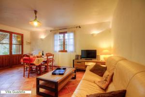 a living room with a couch and a table at Résidence Casa Di Roc in Urtaca