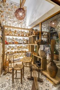 a room filled with lots of wooden chairs and vases at Limeri Traditional Guest House in Monólithos