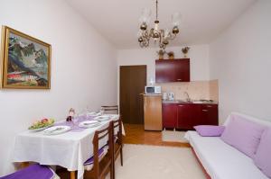 a living room with a table and a couch at Apartment Katarina in Crikvenica