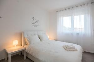 Postel nebo postele na pokoji v ubytování Apartments Residence Romance