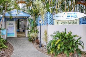 a entrance to a beach paradise building with palm trees at Surfers Beach Holiday Apartments in Gold Coast