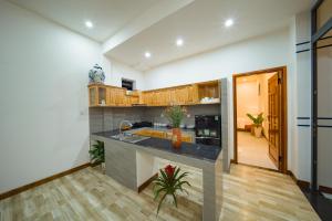 a kitchen with a large island in a room at An Bang Star Homestay in Hoi An