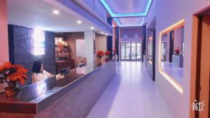 a hallway with a woman sitting at a counter in a store at Hotel Plaza Arteaga in Monterrey