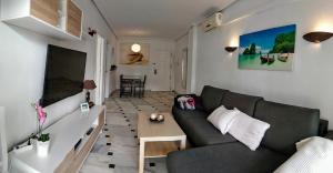 a living room with a couch and a table at Sol y Relax, Lubina Sol in Mijas Costa