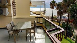 a balcony with a table and chairs and the ocean at Sol y Relax, Lubina Sol in Mijas Costa