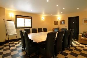 a conference room with a wooden table and chairs at Pretty River Valley Country Inn in Nottawa