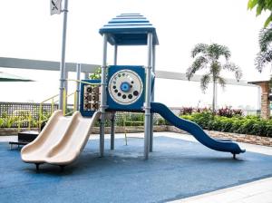 a playground with a slide and a play equipment at 4Q tower D Manhanttan Heights Cubao QC in Manila