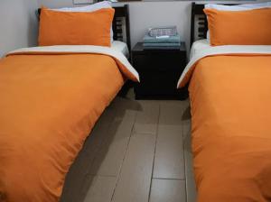 two beds sitting next to each other in a room at 4Q tower D Manhanttan Heights Cubao QC in Manila