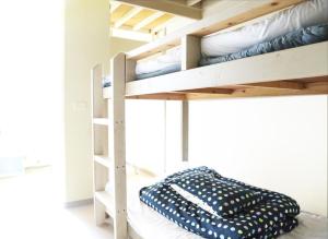 a bunk bed room with two bunk beds at Little Asia Guest House in Naha