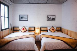 Postel nebo postele na pokoji v ubytování AROMA Ha Long Hotel + 37 fotografií