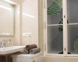 a bathroom with a sink and a glass shower at Paul's palace - absolute center! in Bratislava