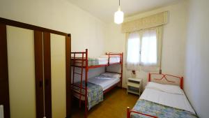 a room with two bunk beds and a window at Villetta Logonovo in Lido di Spina +51 photos