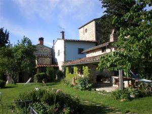 a large stone house in a grassy yard at Agriturismo Podere Torre in Greve in Chianti