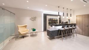 a bar in a room with chairs and a counter at Castello Hotel in Rio