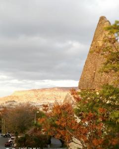 a large stone building with a view of the mountains at Ufuk hotel Pension in Göreme