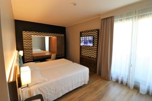 Ένα ή περισσότερα κρεβάτια σε δωμάτιο στο Hotel Domenichino