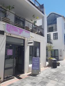 a building with a sign in front of it at 180 Eden on the Bay, Big Bay in Big Bay