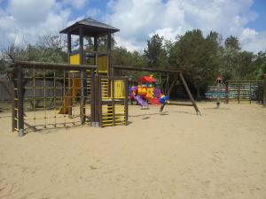 a playground on the beach with a slide and swings at Hotel Valdor in Cavallino-Treporti