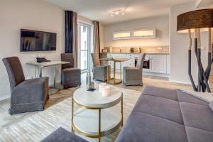 a living room with a couch and a table at Hotel Hafen Flensburg in Flensburg